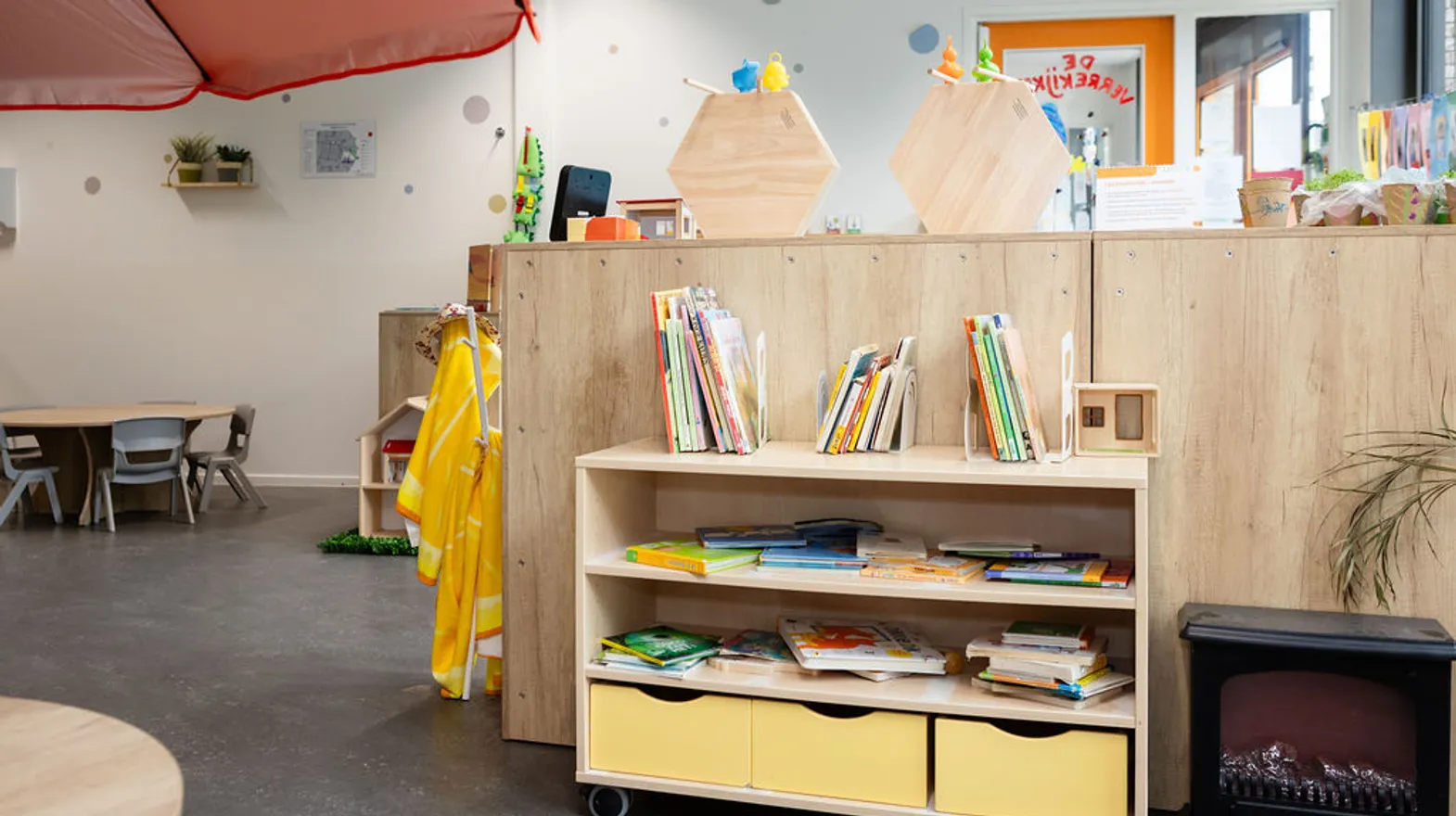 De groepsruimte met boekenkast van peuteropvang Teun bij kinderopvang Kind&co Ludens