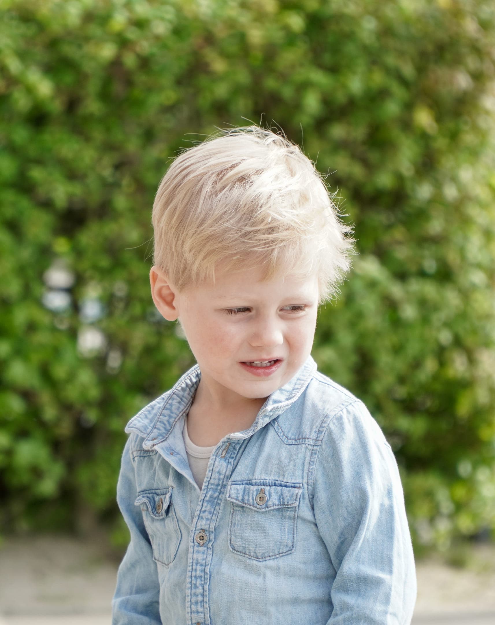 Kind staat buiten bij de heg bij gastouder van kinderopvang Kind&co ludens