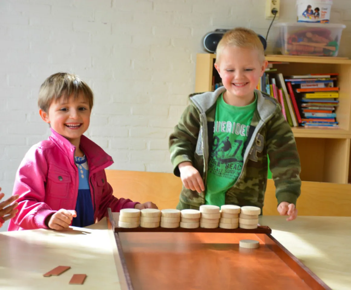 Kinderen sjoelen samen bij buitenschoolse opvang Batau van kinderopvang Kind&co Ludens