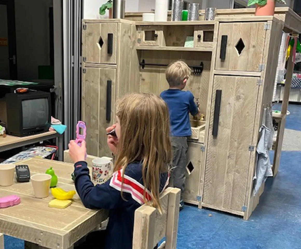 Kinderen spelen in de huishoek bij buitenschoolse opvang boesboes van kinderopvang Kind&co Ludens