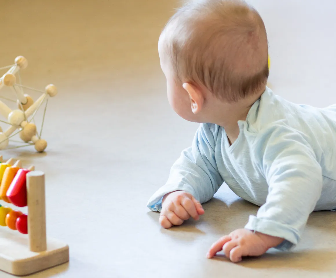 Baby ligt te spelen bij kinderdagverblijf Klavertje, kinderopvang Kind&co ludens
