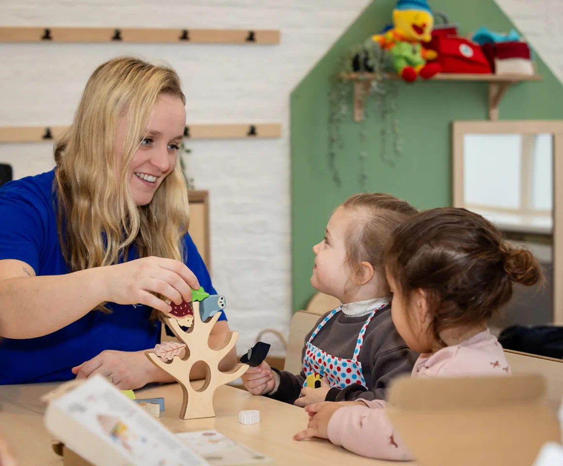 Kinderen spelen samen met de pedagogisch medewerker een spel aan tafel bij Peuteropvang Villa Kapitein Ouderkerk ad Amstel van kinderopvang Kind&co ludens