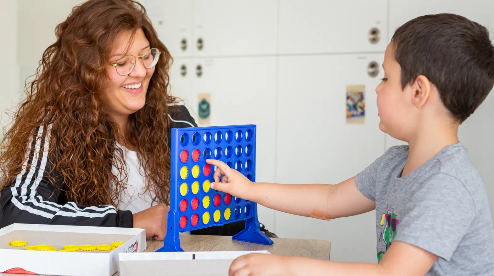 Kind speelt samen met een pedagogisch medewerker een spel bij kinderopvang Kind&co ludens
