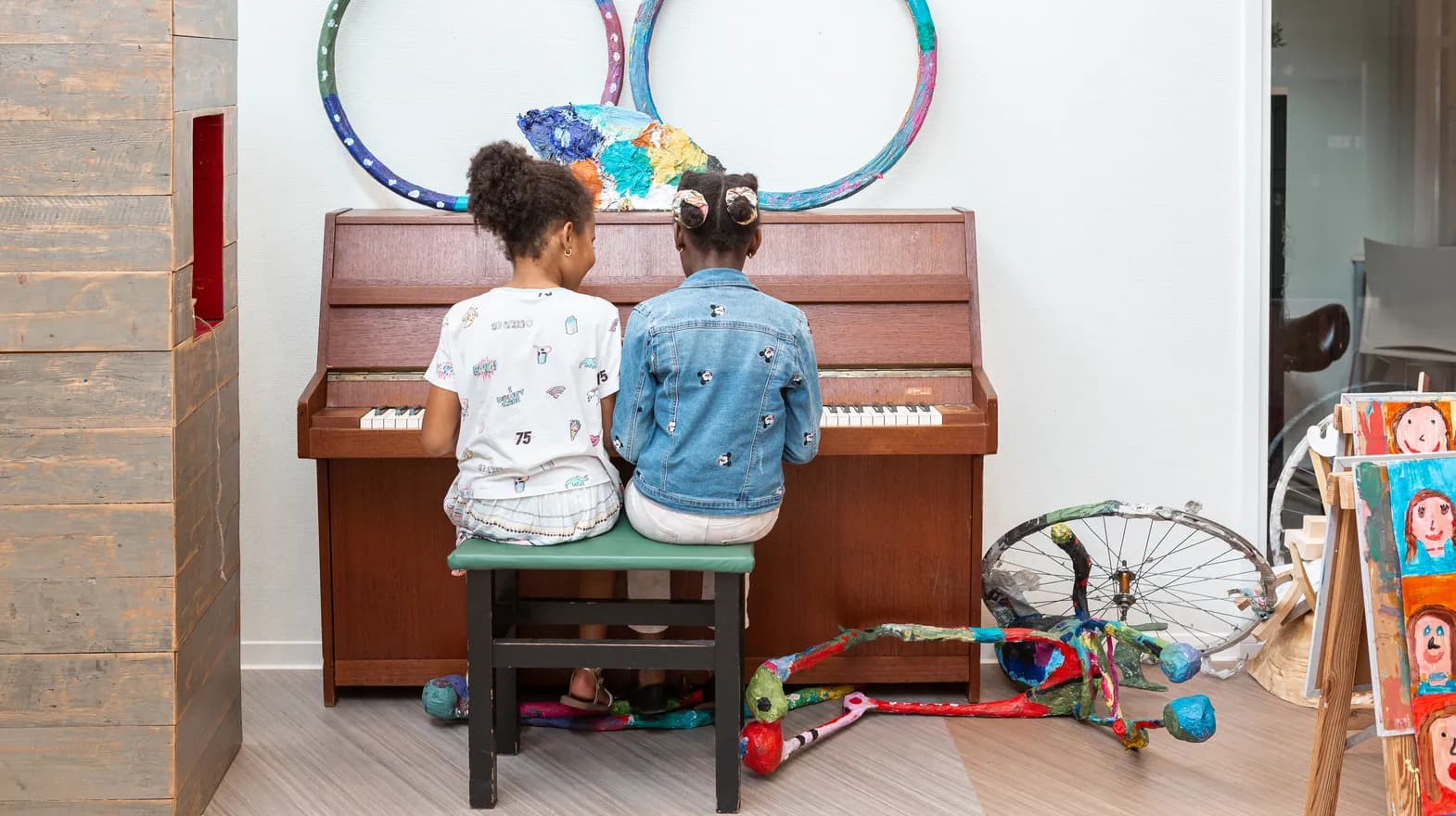 Kinderen spelen samen op de piano bij de BSO van kinderopvang Kind&co ludens