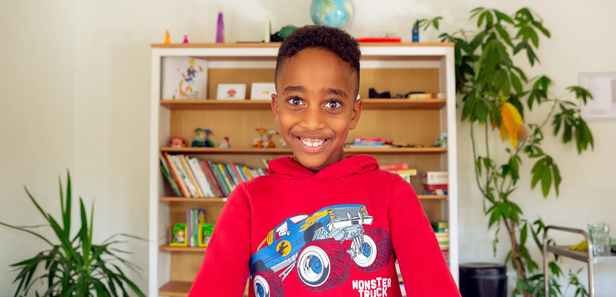 Kind bij de BSO lacht heel blij en straalt bij kinderopvang Kind&co ludens