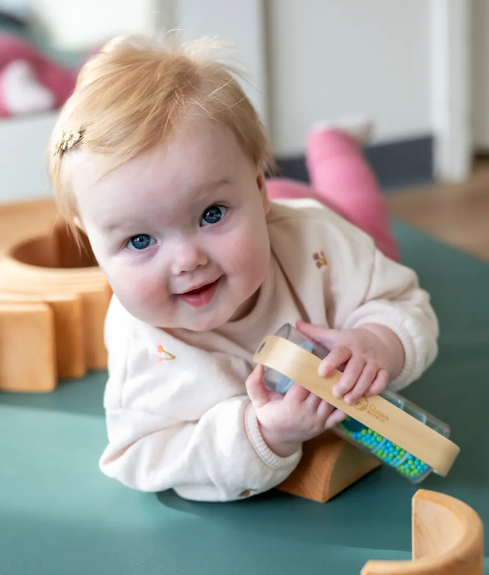 Baby speelt op een mat bij kinderopvang Kind&co ludens