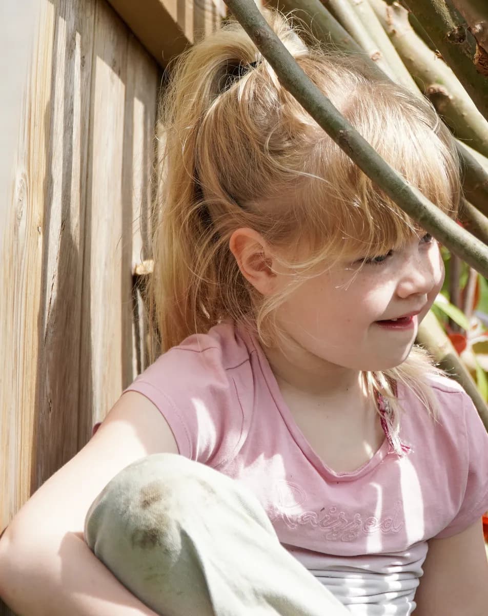 Kind speelt buiten in Wilgentakken huisje bij gastouder van kinderopvang Kind&co ludens